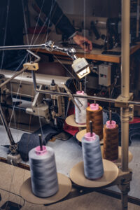 Picture of a tailor's desktop at a sewing workshop.